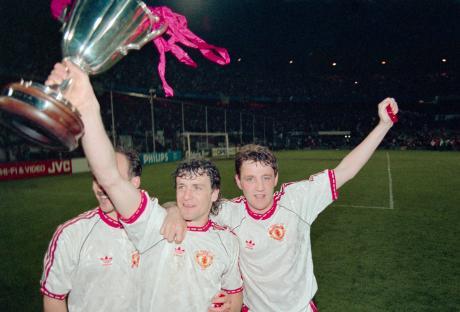 Manchester United players celebrating with the Cup Winners' Cup trophy.
