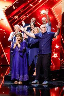 Group of people waving on Britain's Got Talent.