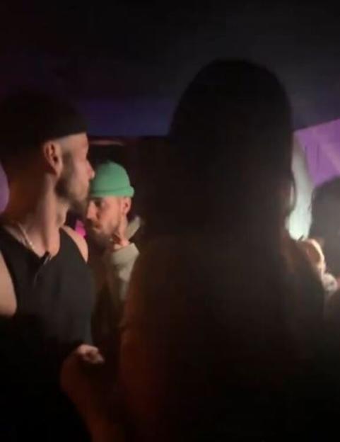 Justin Bieber in a green beanie in a crowd.
