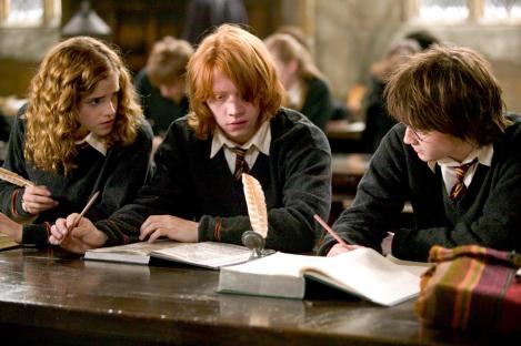 Hermione, Ron, and Harry in a classroom scene from Harry Potter and the Goblet of Fire.
