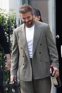 David Beckham carrying a bottle of wine.