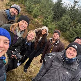 Group photo of people in a forest.