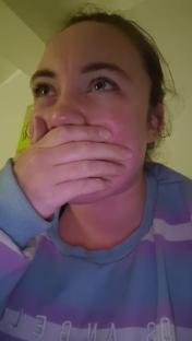 Woman covering her mouth in shock.