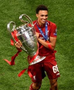 Trent Alexander-Arnold holding the UEFA Champions League trophy.