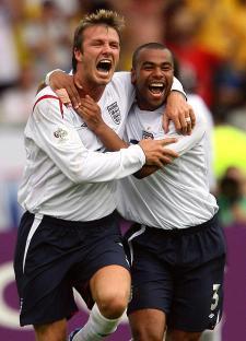 David Beckham and Ashley Cole celebrating a goal.