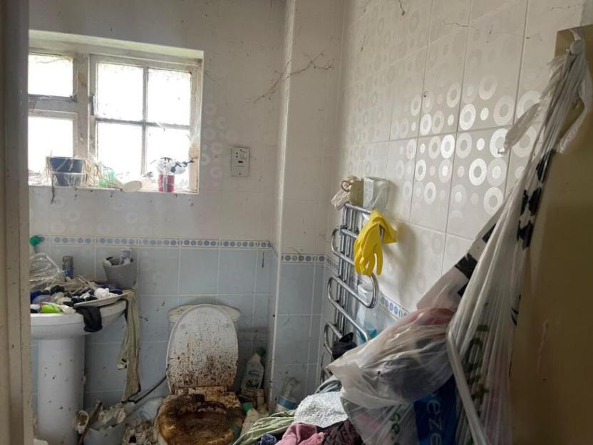 Extremely dirty and cluttered bathroom.