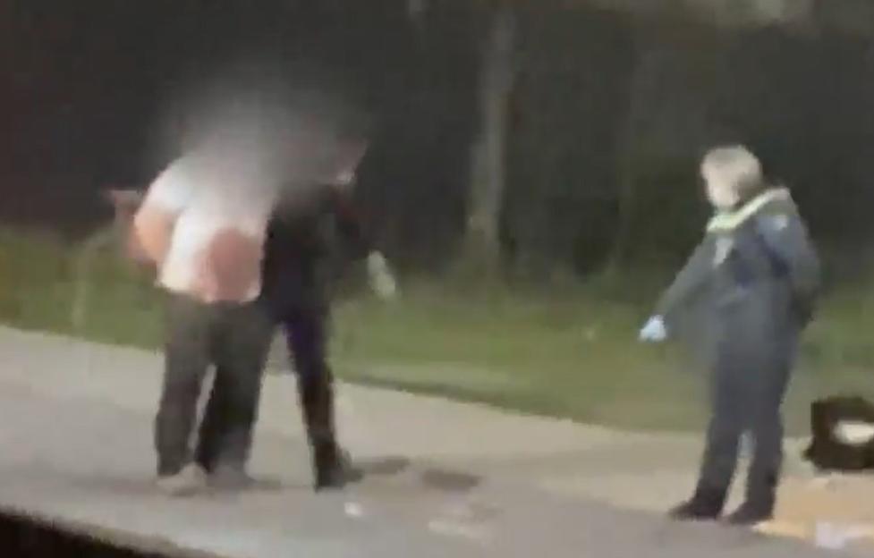 Police officers apprehending a suspect.