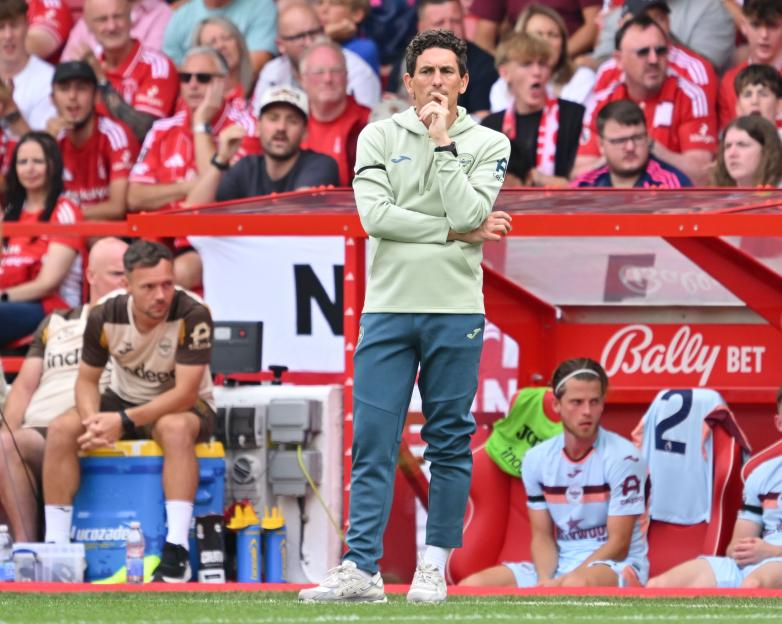 Brentford manager Keith Andrews on the sidelines of a football match.