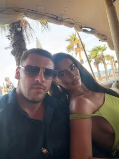 Couple posing for a selfie outdoors.