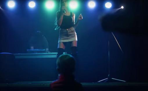 Singer on stage performing.