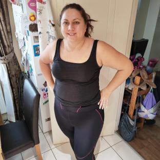 Woman in black workout clothes.
