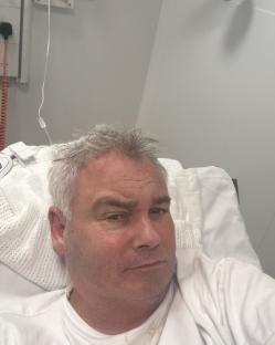 Eamonn Holmes in a hospital bed.