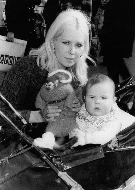 Linda Calvey with her daughter and a monkey in a sweater.