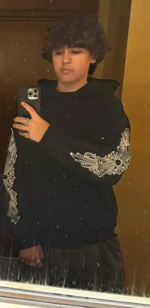 Mason Disick taking a mirror selfie with Reign Disick in a bathroom.