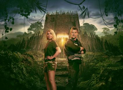 Promotional image of Holly Willoughby and Bear Grylls in front of a jungle structure.