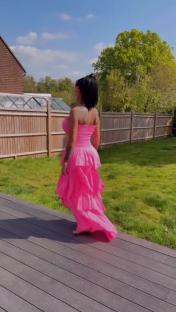 Woman in pink dress walking away from camera.