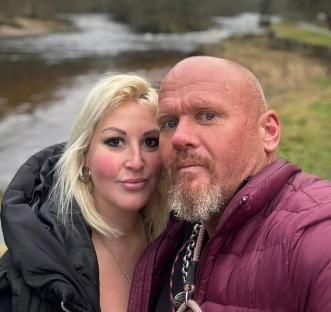 Photo of a couple by a river.