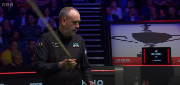Snooker player holding his cue.