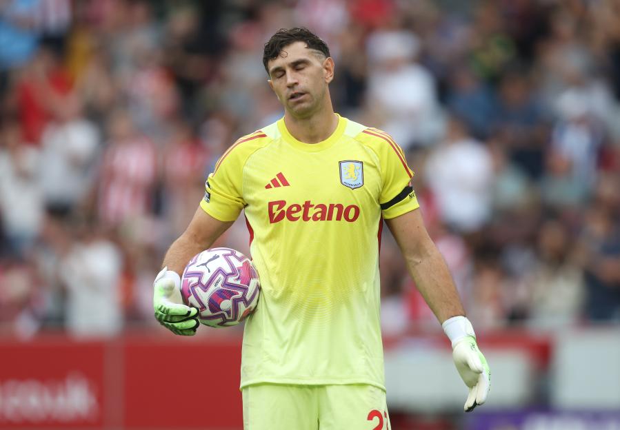 Emiliano Martínez, Aston Villa goalkeeper, holding a soccer ball.