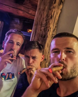 Three men smoking cigars.