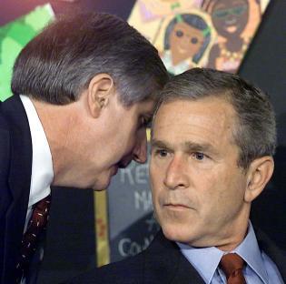 President George W. Bush being told about the September 11th attacks.