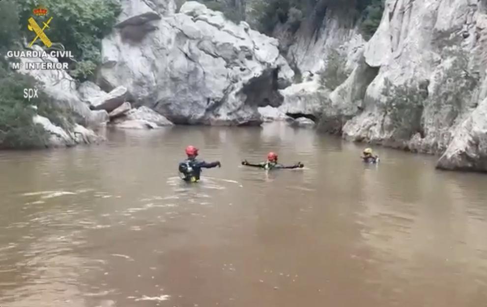 Search and rescue team in flooded canyon.