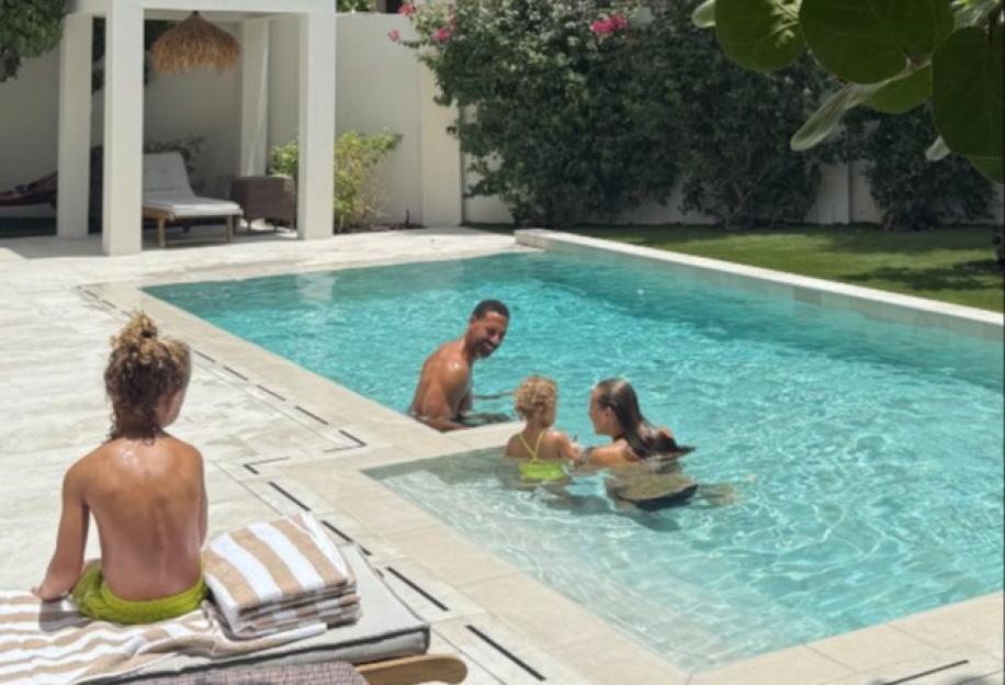 Rio Ferdinand and his family in a swimming pool in Dubai.