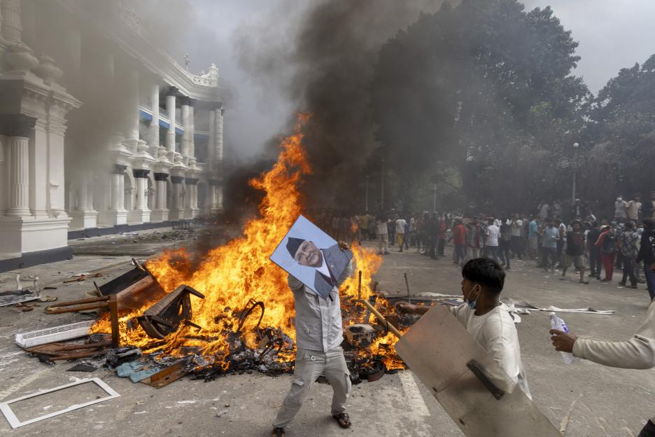 A protester burns a picture of the resigned Prime Minister K.P. Sharma Oli during a demonstration in Kathmandu, Nepal.