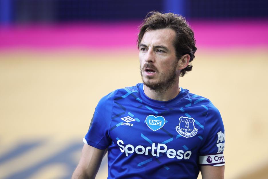 Everton defender Leighton Baines in a blue jersey with the NHS logo.