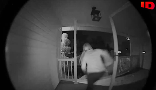 Night vision security camera footage of a person stealing a package from a porch.