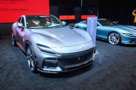 Silver Ferrari Purosangue at auto show.