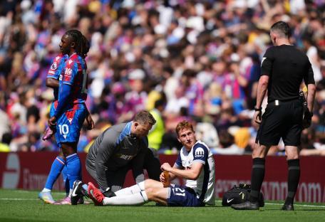 Dejan Kulusevski receiving medical attention on the soccer field.