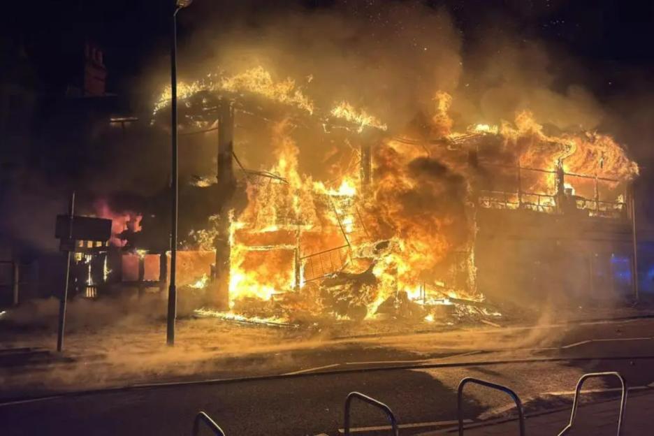 Huge blaze rips through building as homes evacuated and residents urged to ‘keep windows and doors shut’