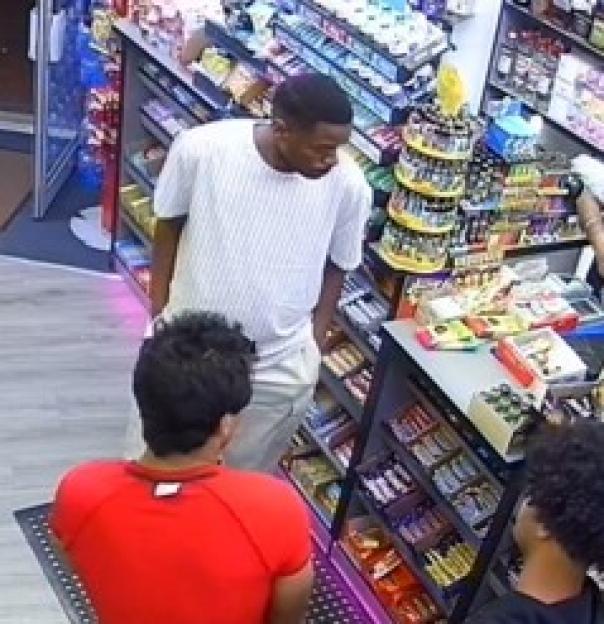 CCTV image of three men in a shop.