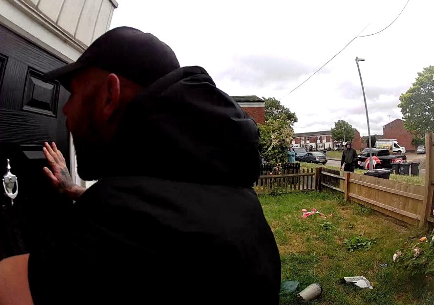 Alistair Palmer banging on a door while Harry Palmer looks on from the garden.