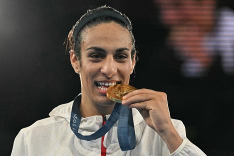 Algerian boxer Imane Khelif holding her gold medal.
