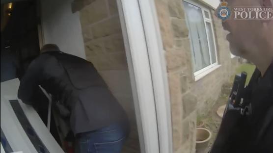 Police officers raiding a house during a County Lines drug bust.