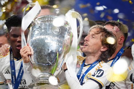 Luka Modric holding the Champions League trophy.