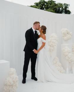 Dani Dyer and Jarrod Bowen kissing at their wedding.