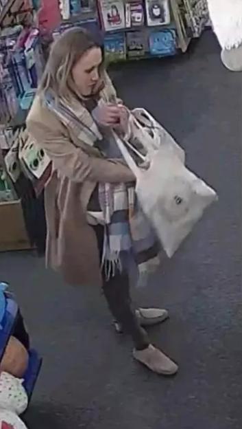 CCTV image of a woman shoplifting.