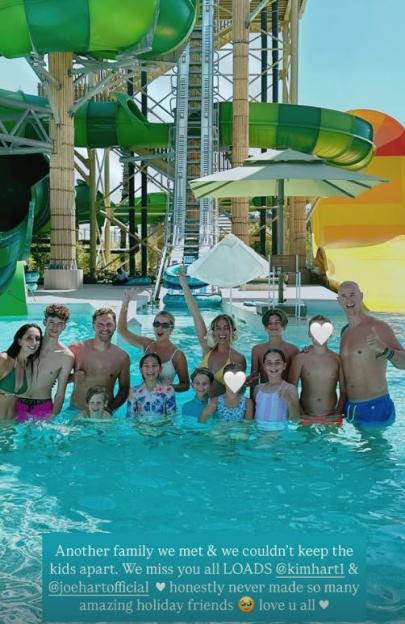 Large group of people in a pool at a water park.