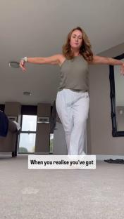Woman in pajamas realizing something.