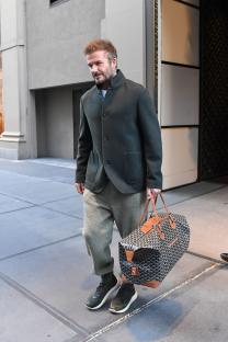 David Beckham walking in Manhattan carrying a Goyard bag.