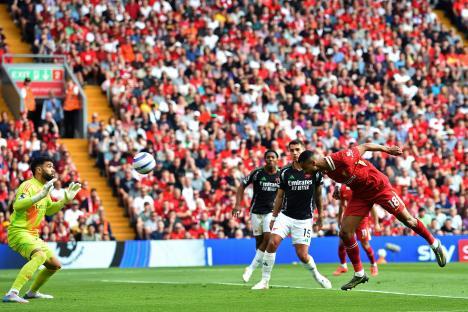 Cody Gakpo heads in a goal during a Liverpool vs Arsenal soccer match.