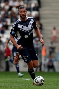 Andy Carroll, a soccer player, running with the ball.