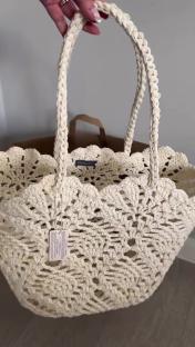 Cream-colored crocheted tote bag.