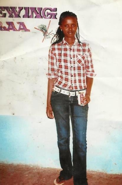 Agnes Wanjiru-Wanjiku posing in a plaid shirt and jeans.
