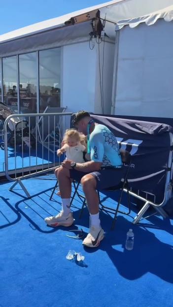 Tommy Fury with his daughter after completing a triathlon.