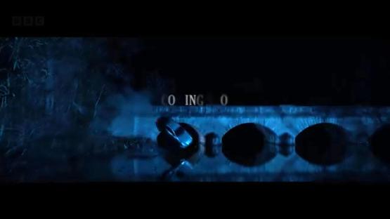 A car plunging off a bridge into a river at night.