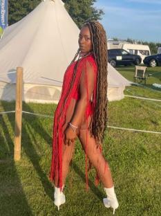 Woman in red fringed outfit and white boots.